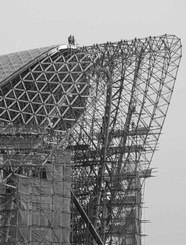 Workers on scaffolding of sports stadium